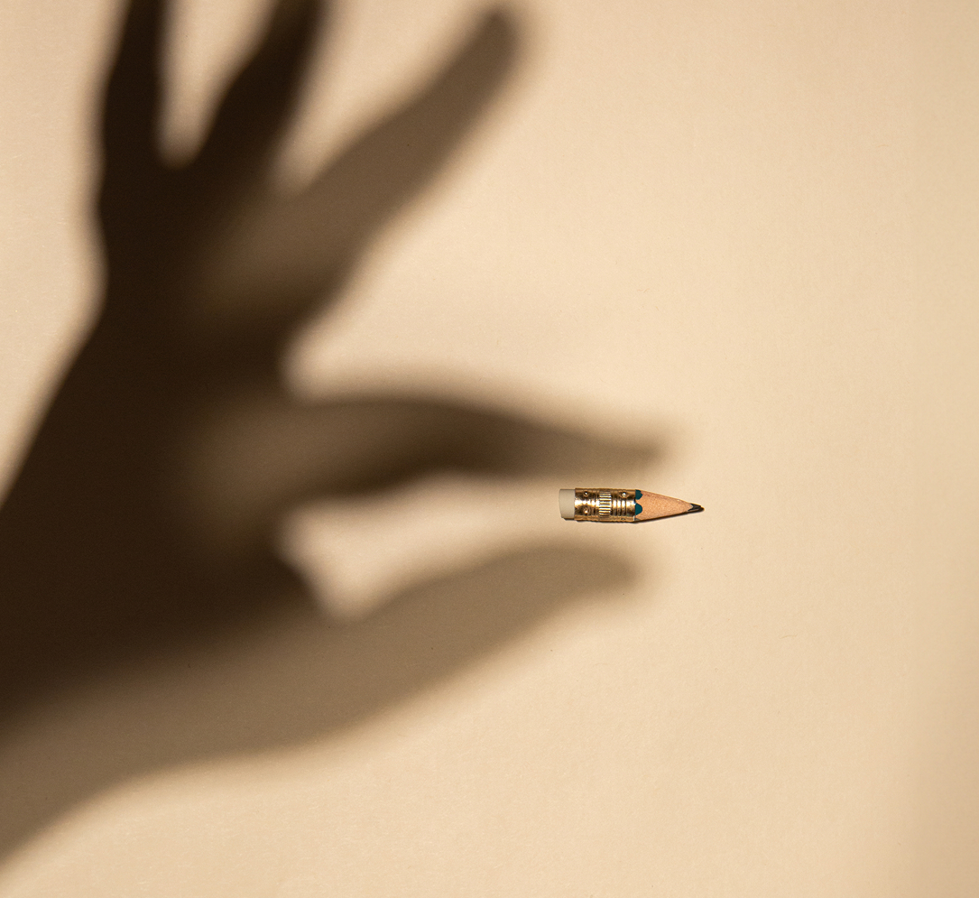 Hand holing a pencil